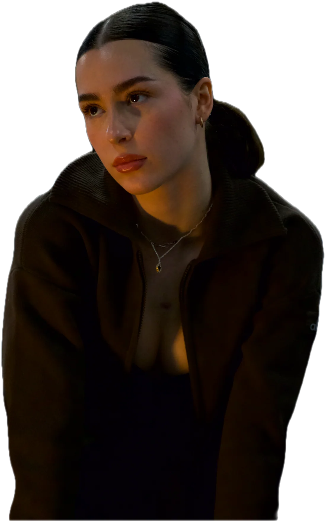Ena in a brown zip jacket, looking off to the side